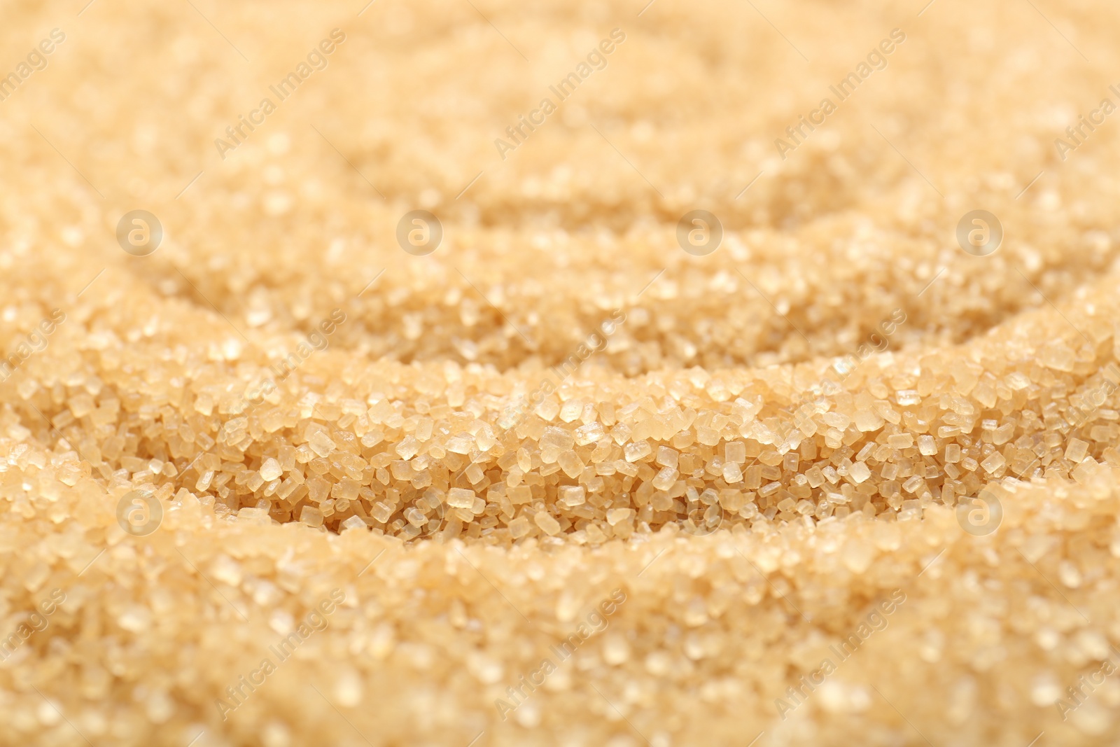 Photo of Granulated brown sugar as background, closeup view