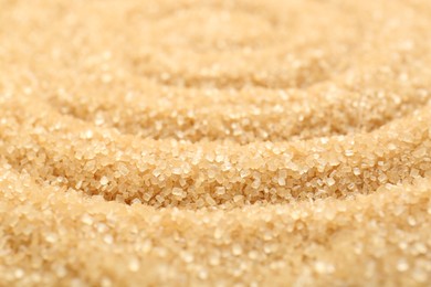 Granulated brown sugar as background, closeup view