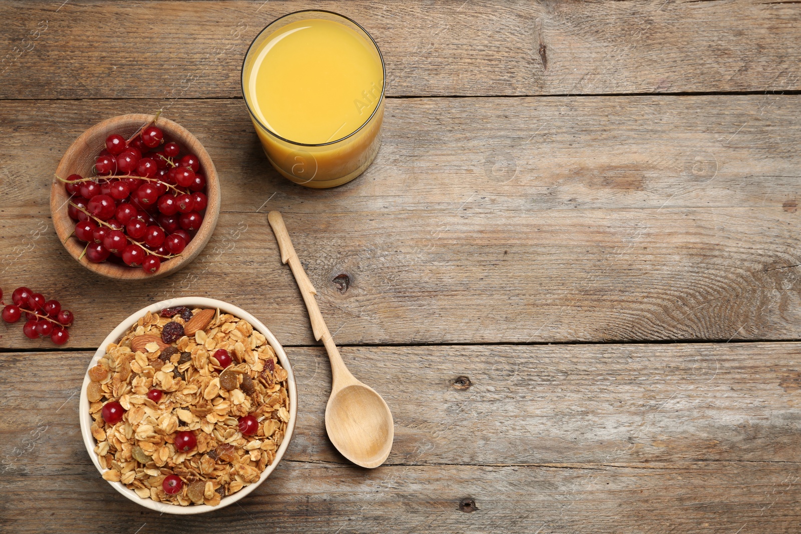 Photo of Flat lay composition with muesli on wooden table, space for text. Delicious breakfast