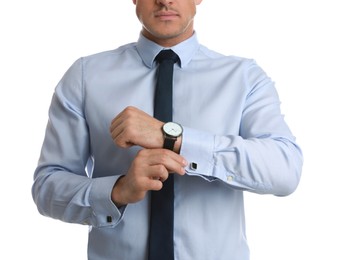 Stylish man putting on cufflink against white background, closeup