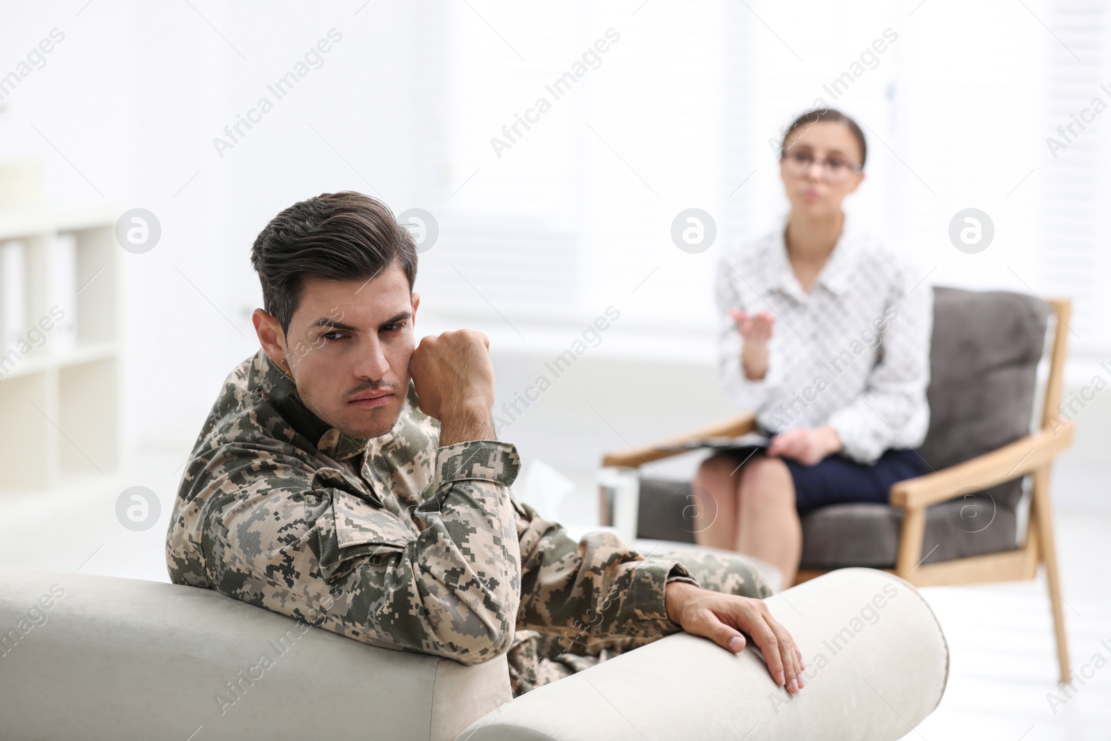 Photo of Male military officer having appointment with psychotherapist in office