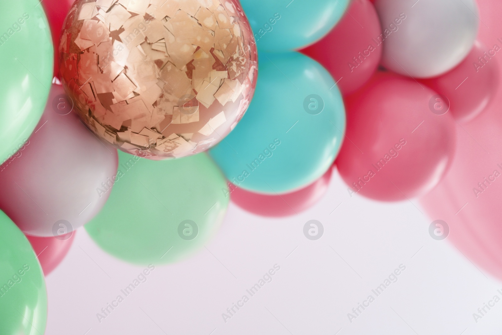 Image of Beautiful colorful balloons on light background, closeup. Party decor