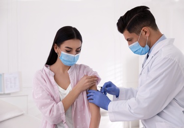 Doctor giving injection to patient in hospital. Vaccination campaign