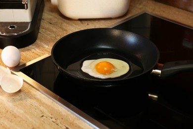 Cooking egg for tasty breakfast in frying pan