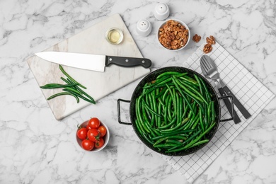 Dish with tasty green beans served for dinner on table, top view