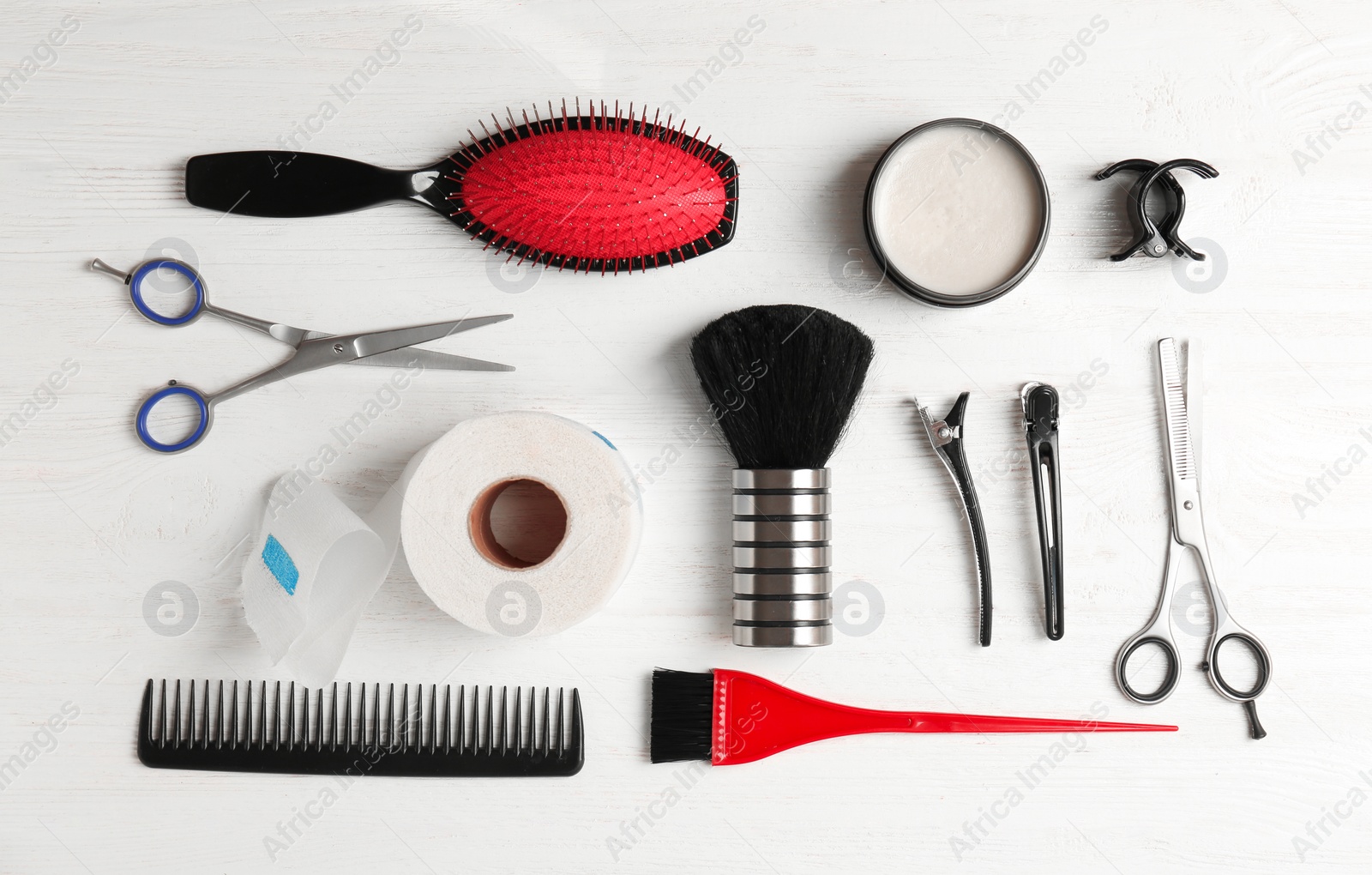 Photo of Flat lay composition with professional hairdresser tools on wooden background