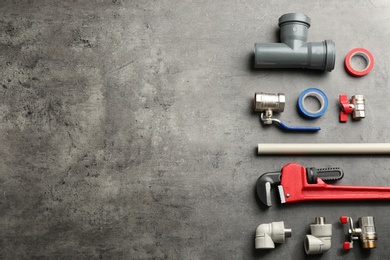 Photo of Flat lay composition with plumber's tools and space for text on gray background