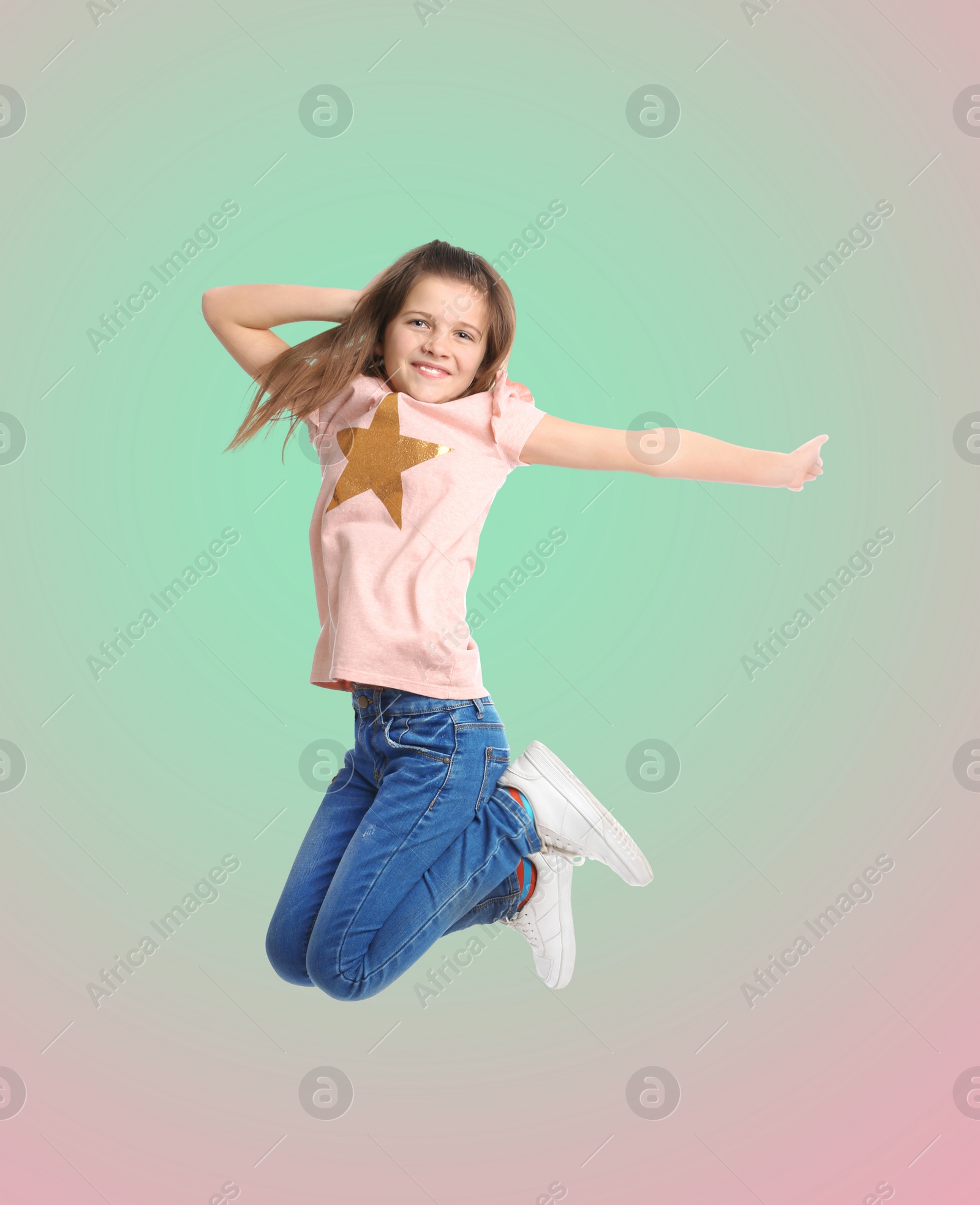 Image of Happy cute girl jumping on color gradient background