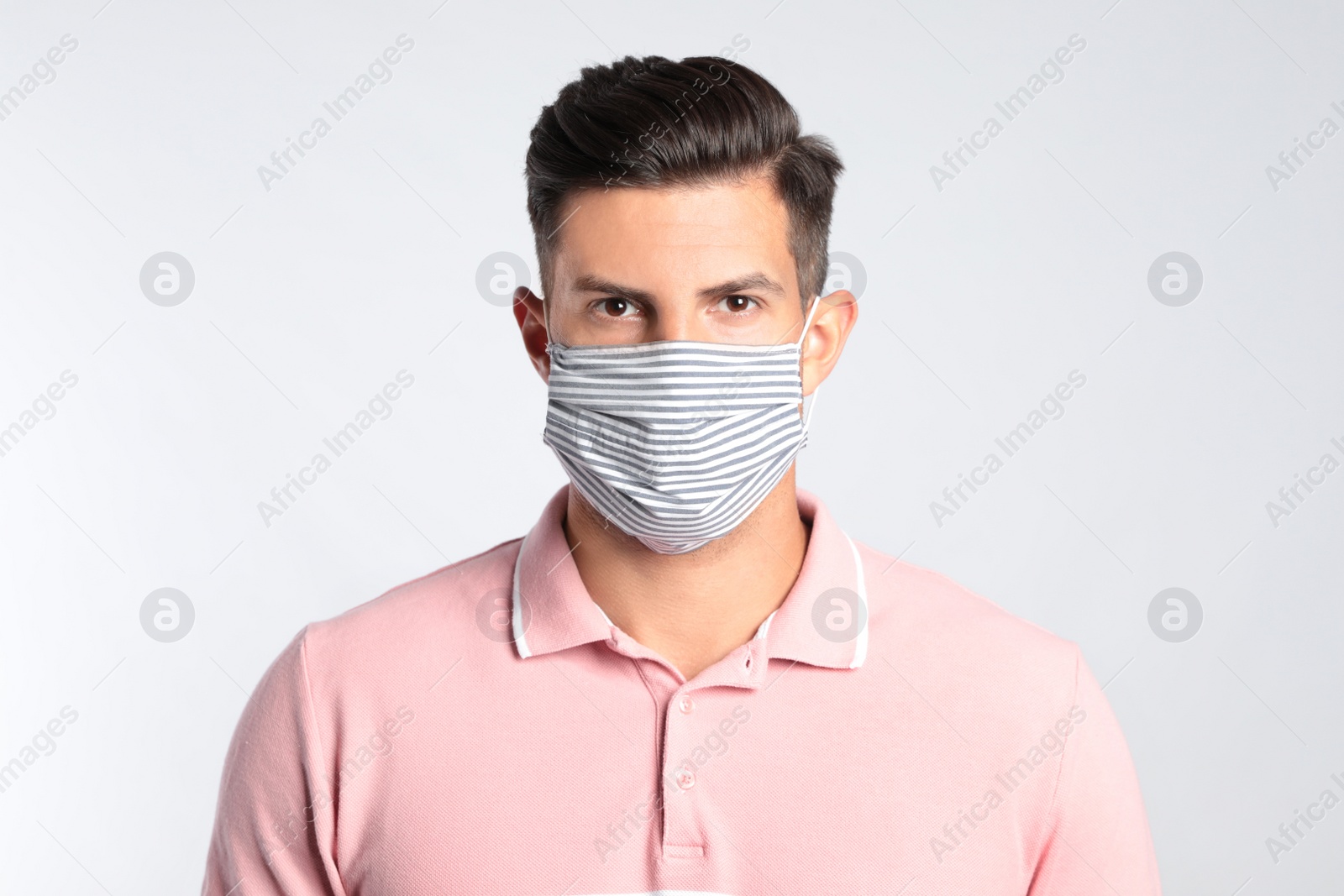 Photo of Man in protective face mask on white background