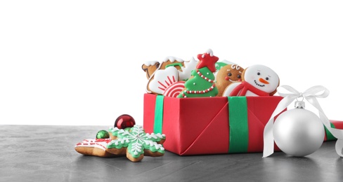 Tasty Christmas cookies on grey table against white background