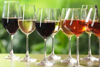 Different tasty wines in glasses on table