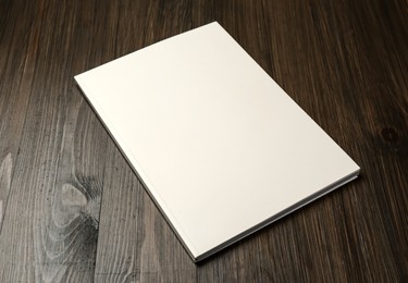 Blank paper brochure on wooden table. Mockup for design