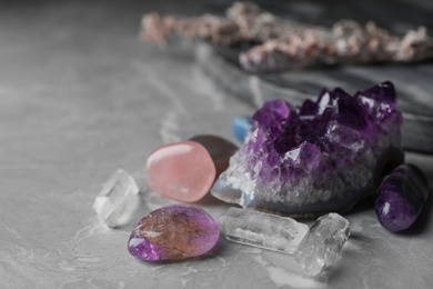 Photo of Many different gemstones on grey marble table