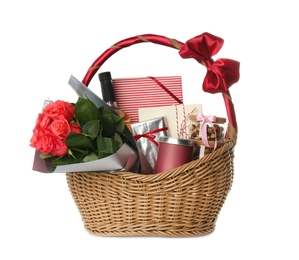 Wicker basket full of presents isolated on white