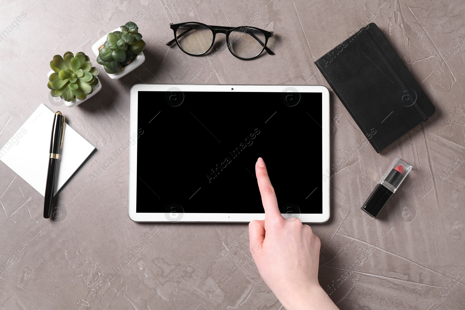 Photo of Online store. Woman using tablet at grey table, top view