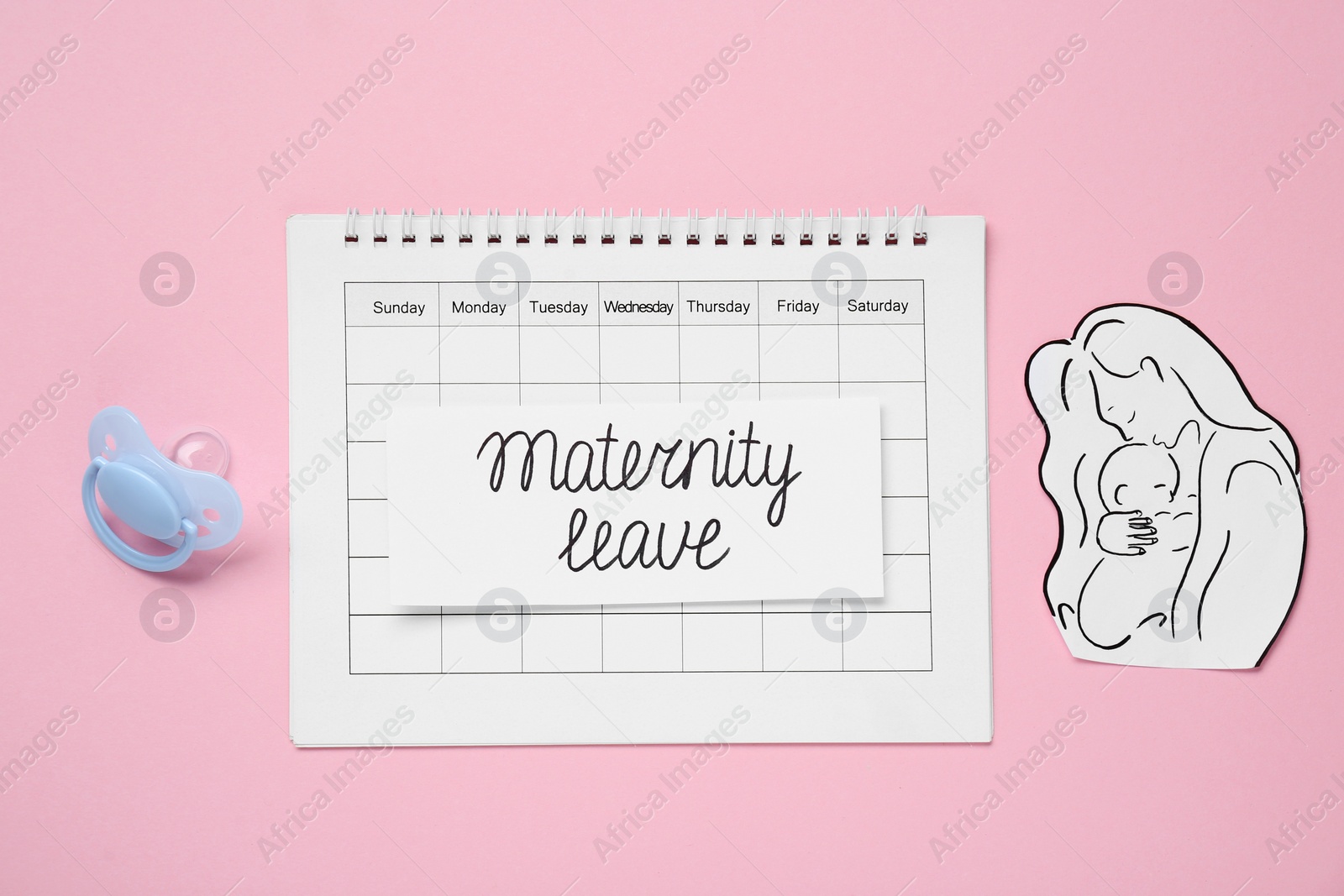 Photo of Flat lay composition with card, paper cutout of mother and child on pink background. Maternity leave concept