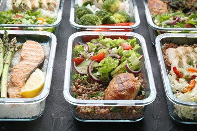 Healthy food. Different meals in glass containers on black table