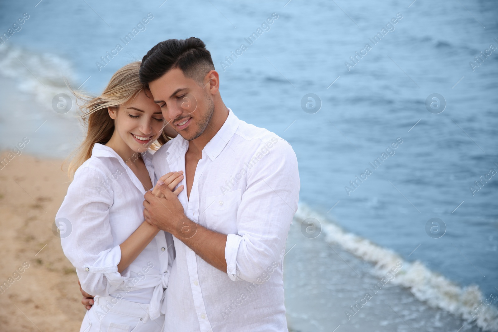 Photo of Happy couple on beach, space for text. Romantic walk
