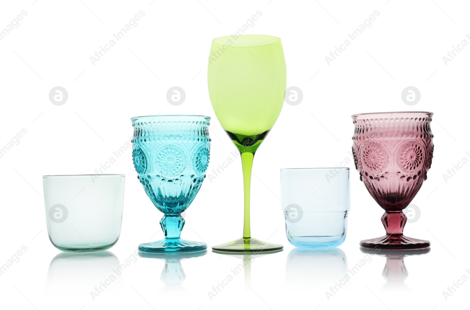 Photo of Set of colorful empty glasses on white background