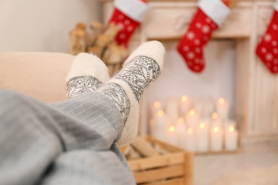 Young woman in living room decorated for Christmas, closeup