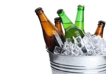 Photo of Metal bucket with bottles of beer and ice cubes isolated on white