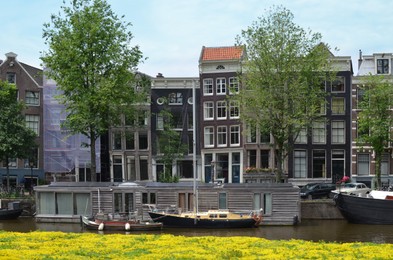 Photo of Picturesque view of town with beautiful buildings near river