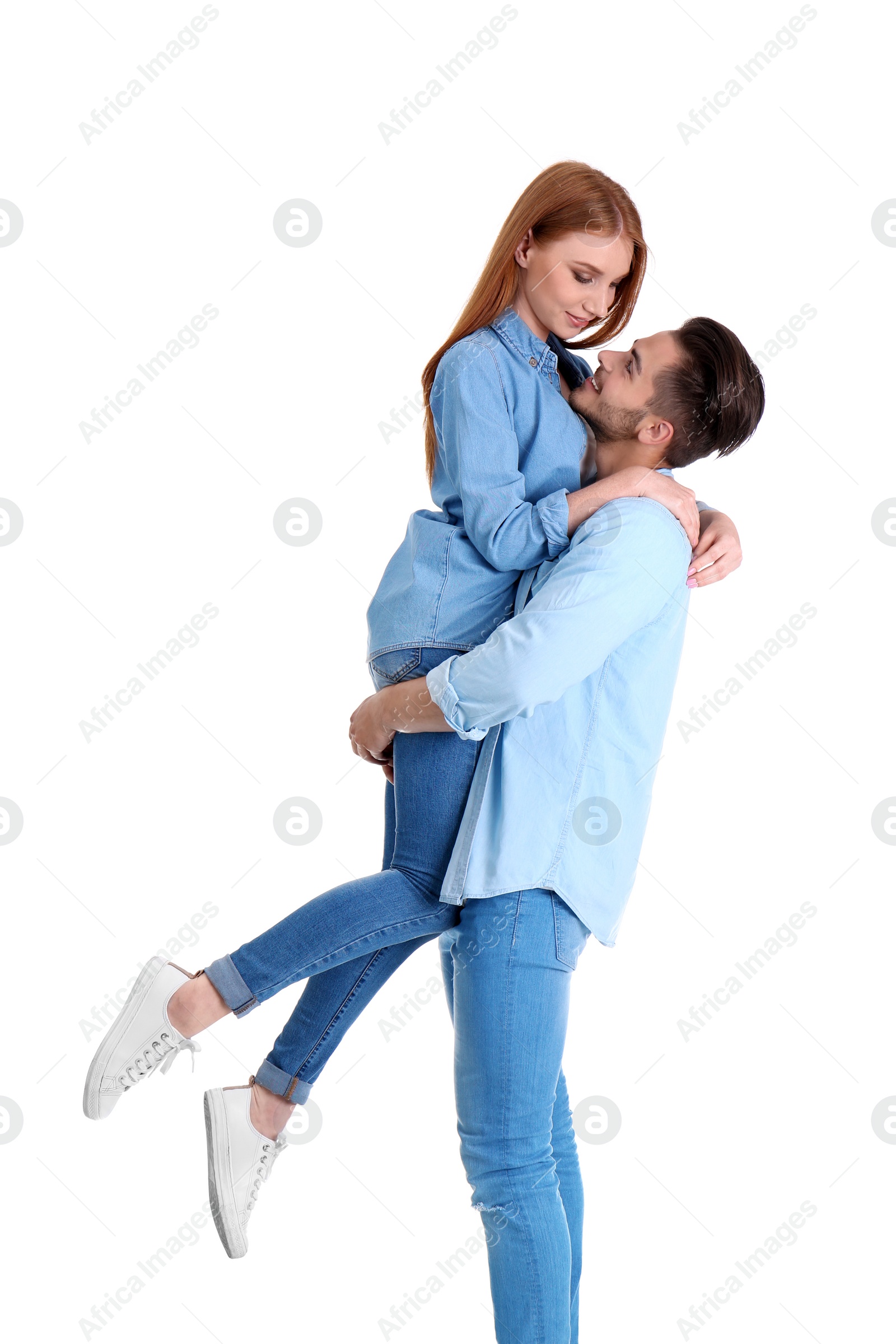 Photo of Young couple in stylish jeans on white background
