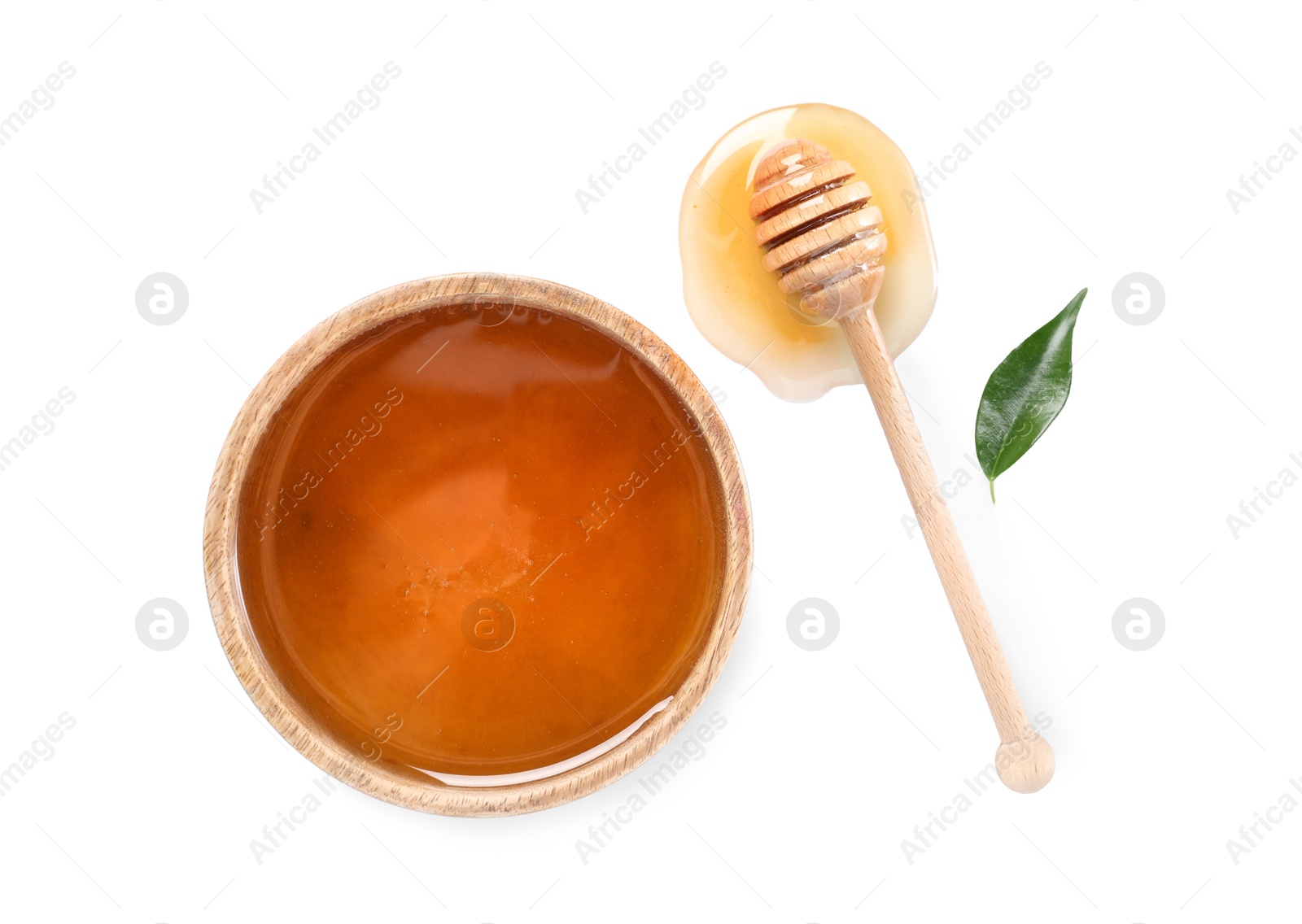 Photo of Tasty honey in bowl, dipper and green leaf on white background, flat lay. Space for text