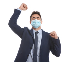 Photo of Emotional businessman with protective mask on white background. Strong immunity concept