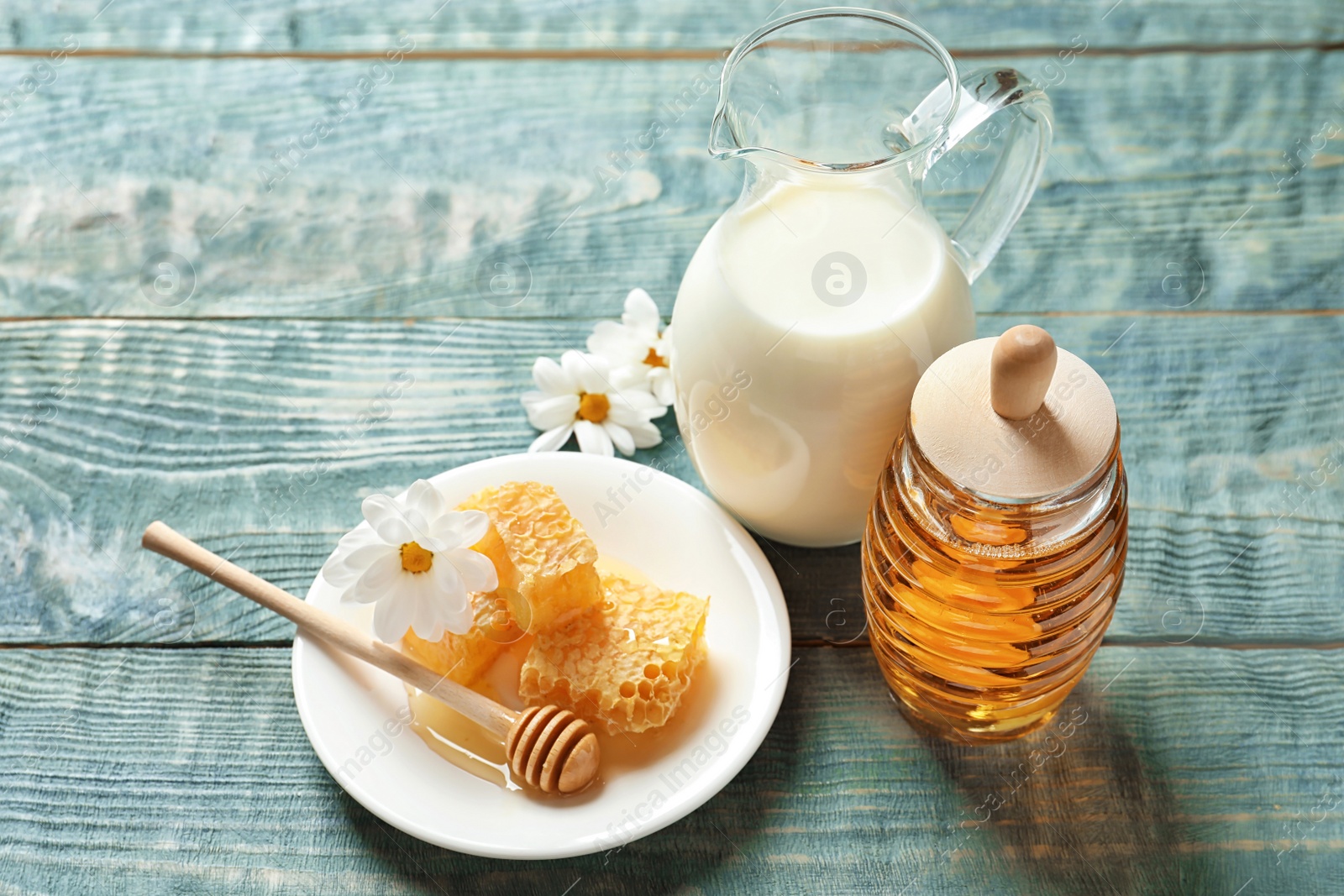 Photo of Beautiful composition with milk and honey on wooden background