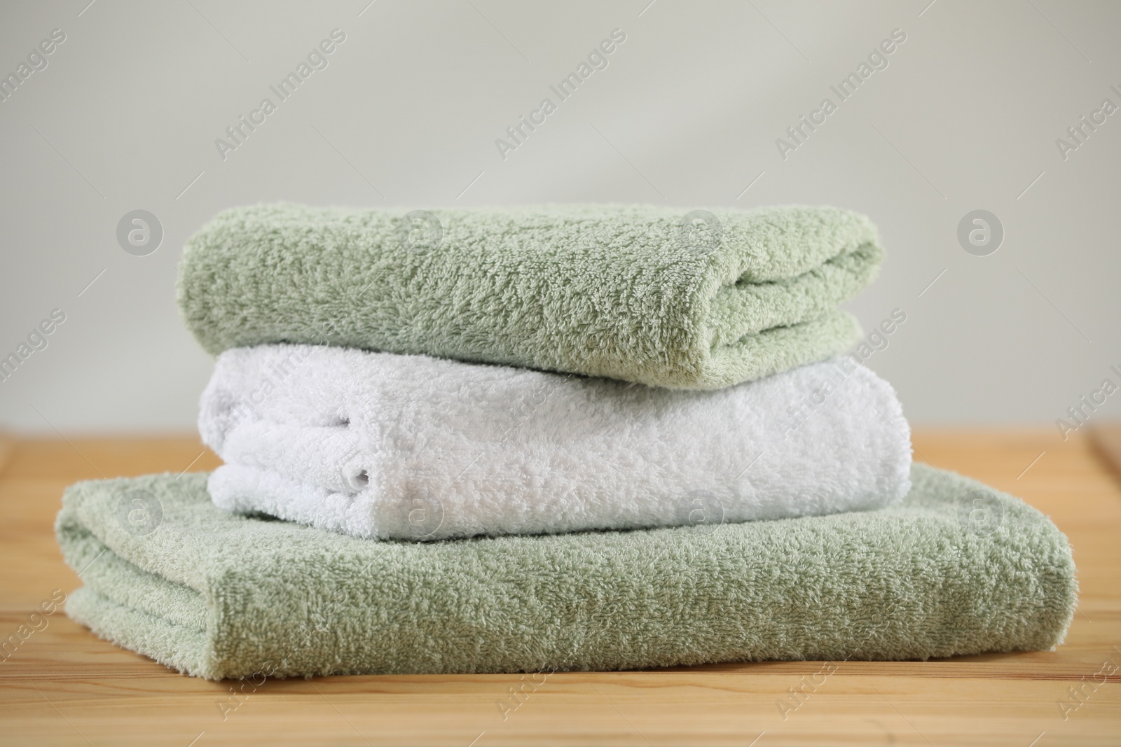 Photo of Stack of folded towels on wooden table