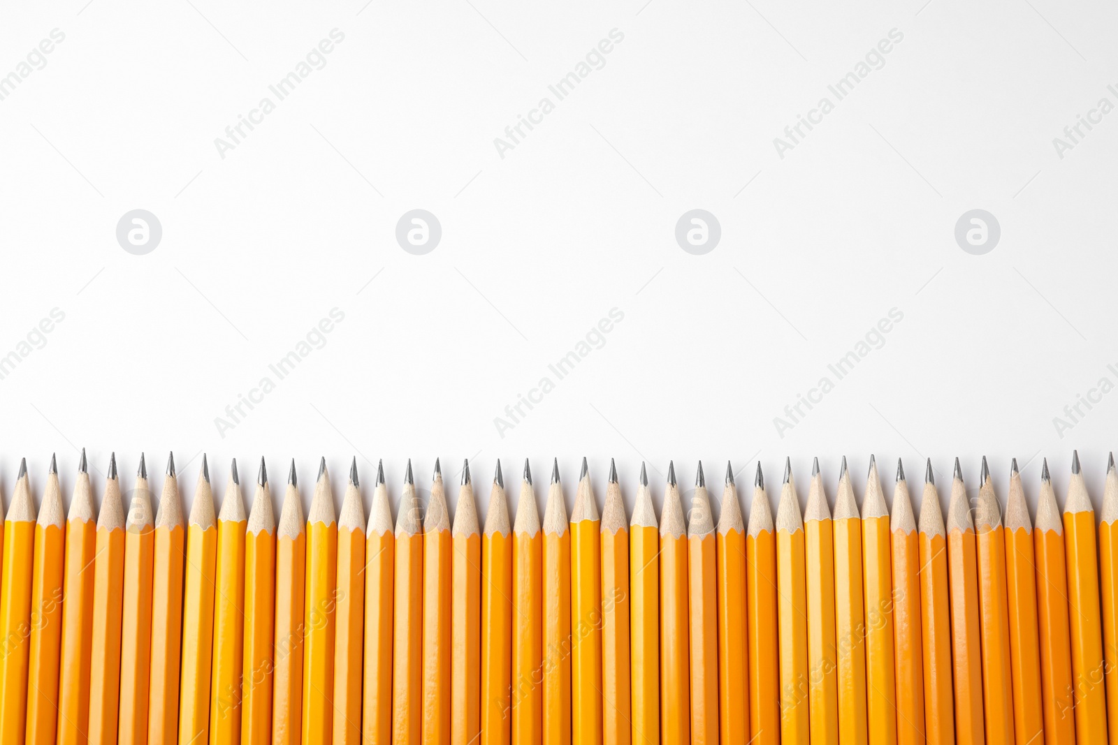 Photo of Graphite pencils on white background, top view. Space for text