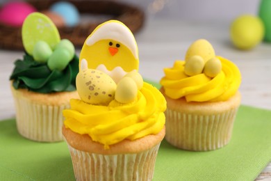 Tasty cupcakes with Easter decor on table, closeup