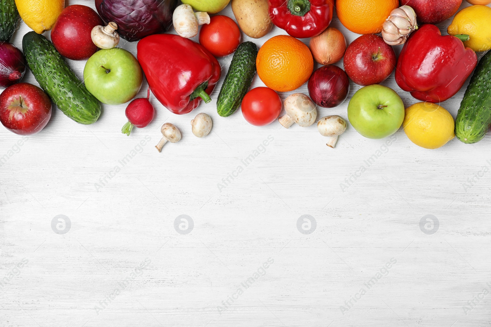 Photo of Fresh fruits and vegetables on white wooden table, flat lay. Space for text