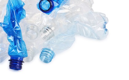 Photo of Crumpled disposable plastic bottles on white background, space for text