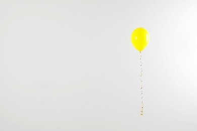 Photo of Bright balloon on light background, space for text. Celebration time