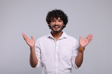 Photo of Handsome smiling man on light grey background