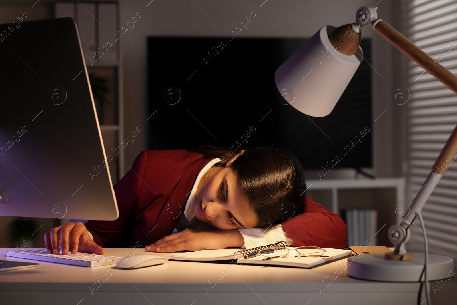 Photo of Tired overworked businesswoman at table in office