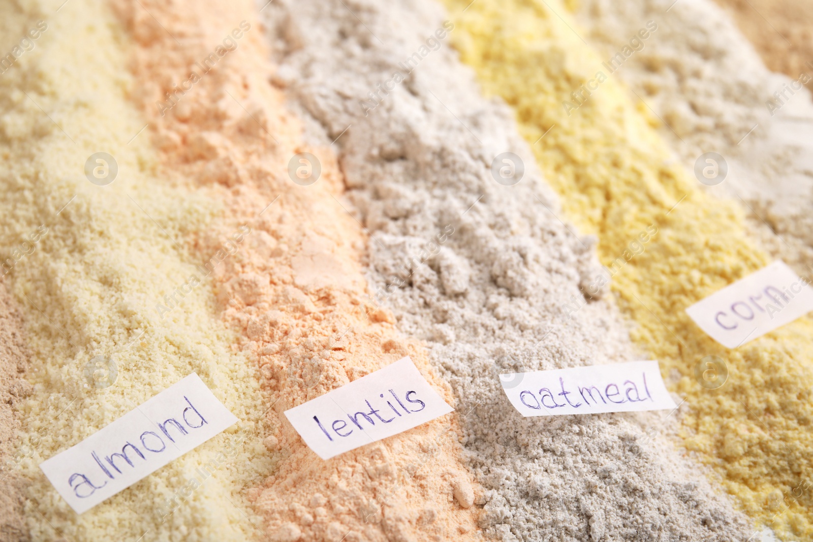 Photo of Different types of flours as background, closeup