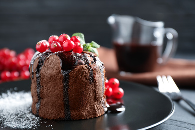 Photo of Delicious warm chocolate lava cake with mint and berries on table, closeup. Space for text