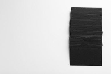 Photo of Blank black business cards on white background, top view. Mockup for design