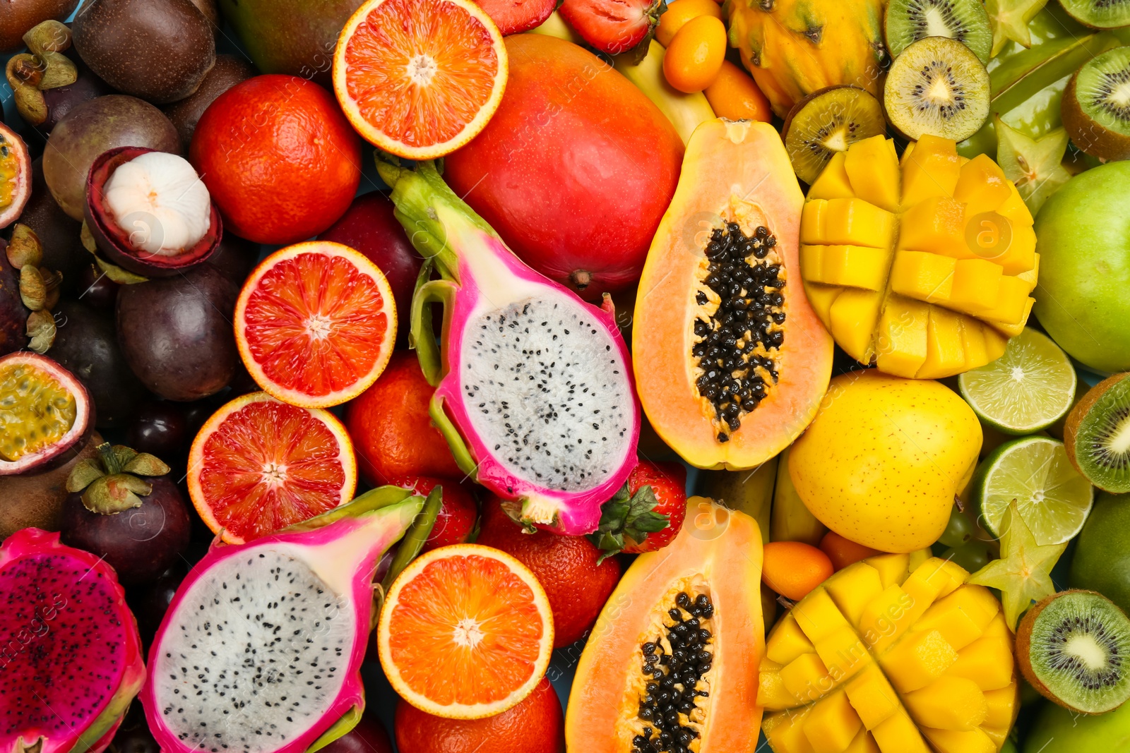 Photo of Many different delicious exotic fruits as background, top view