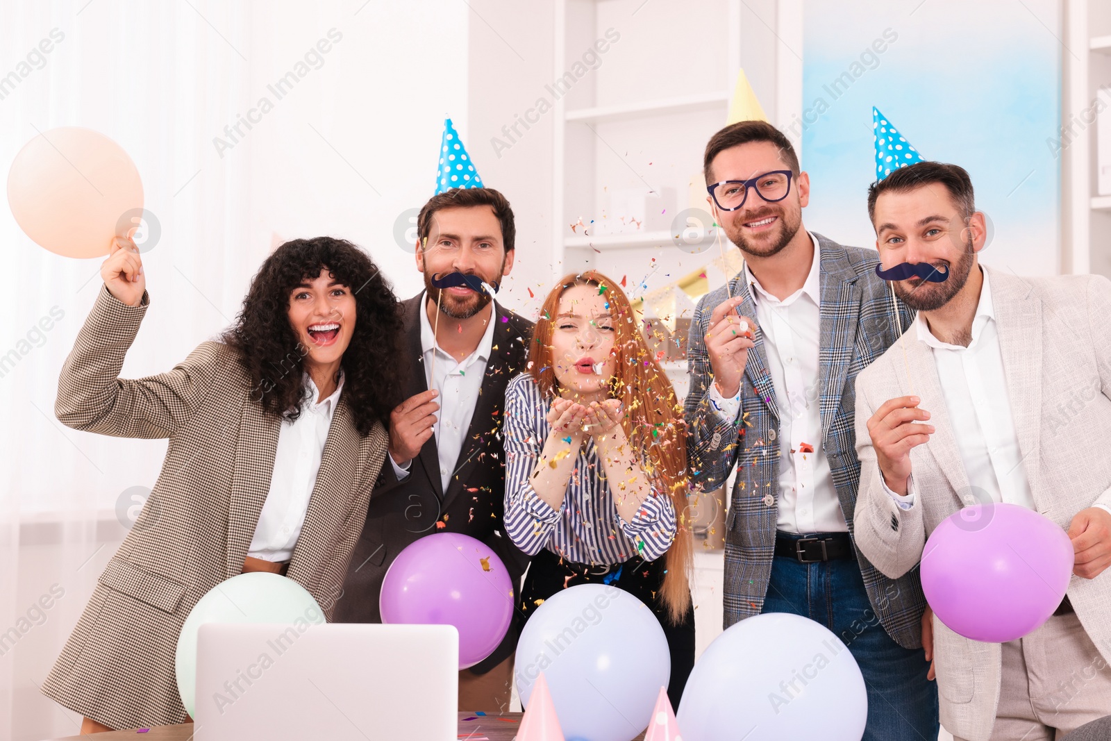 Photo of Coworkers having fun during office party indoors