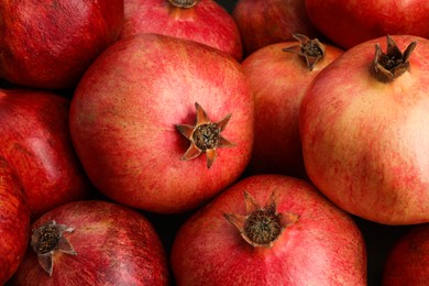 Photo of Many fresh ripe pomegranates as background, closeup