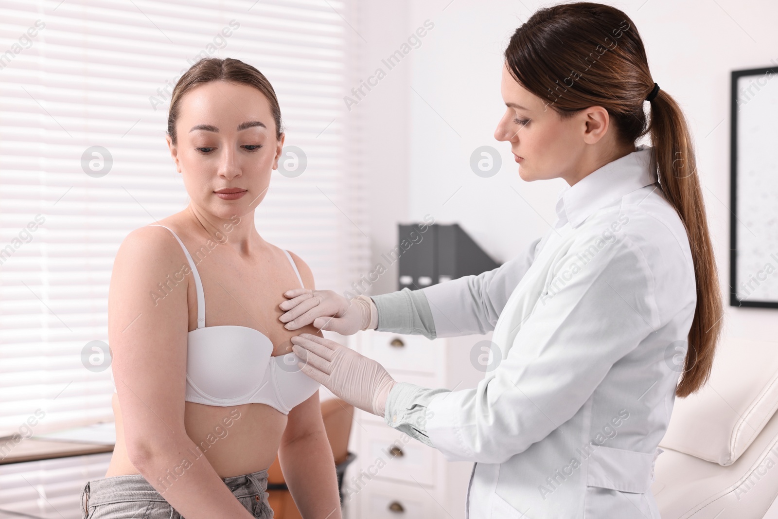 Photo of Mammologist checking young woman's breast in hospital