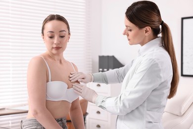 Photo of Mammologist checking young woman's breast in hospital