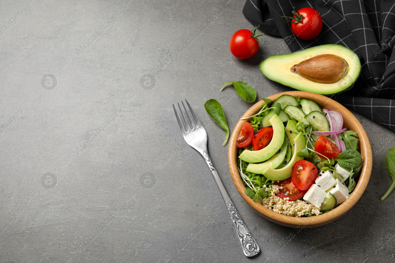 Photo of Delicious avocado salad with quinoa on grey table, flat lay. Space for text