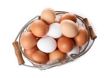 Photo of Fresh chicken eggs in metal basket isolated on white, top view