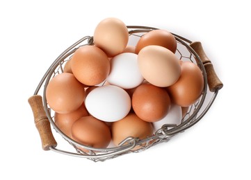 Fresh chicken eggs in metal basket isolated on white, top view