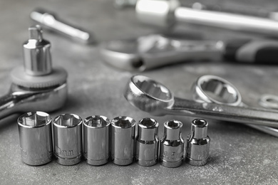 Auto mechanic's tools on grey stone table